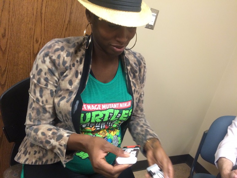 Church of the Reconciler's Kay Simmons learns to use a naloxone injector. Simmons says having it on hand will help the church be more prepared for overdoses on church property. 
