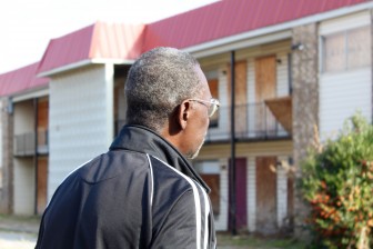 Neighborhood president John Harris observes a vacant apartment complex in North Titusville. 