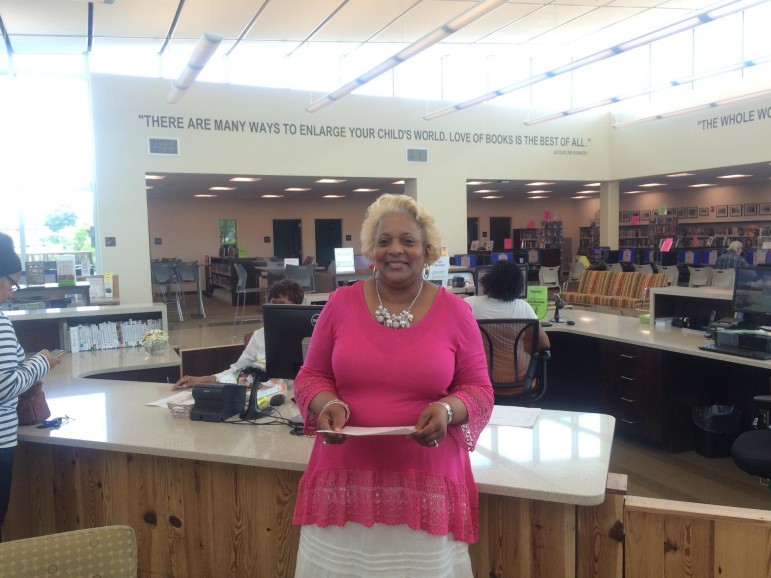 Deborah Blackmon, Branch Manager at Pratt City Library, stands near the new library's circulation desk. 