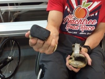 Roberts uses these "hard gloves" to grip the push ring on his racing chair. 