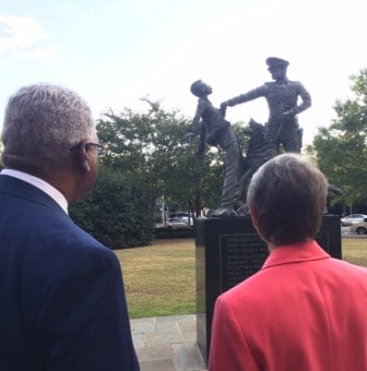 Secretary of the Interior Sally Jewell and Birmingham Mayor William Bell discuss one of the statues in Kelly Ingram Park that help tell the park's story. 