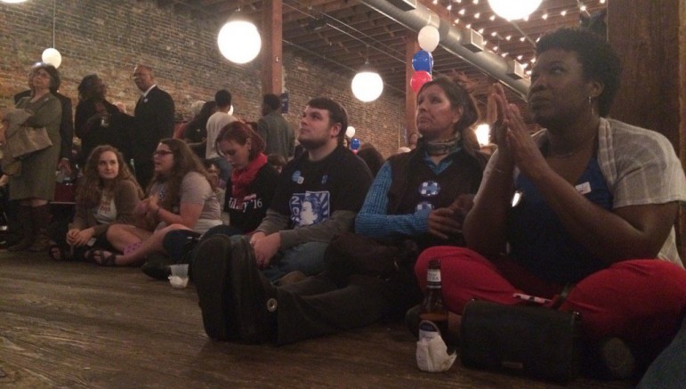 Democratic supporters watch election returns at a gathering in Birmingham Tuesday.
