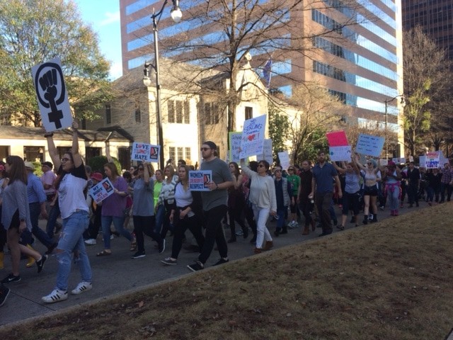 Protesters march up 20th St. toward Linn Park. 