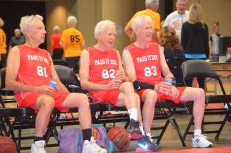 From left,  Tom, Dan and John Twomey take a break from the action during their first basketball game against the Pitt Bulls. Their PassItToMe team went on to win with a score of 38 to 19.