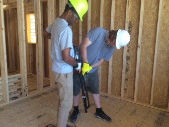 Students use screws to fasten sub-floor to the frame of SURVIV(AL) house. Usually nails are used for this purpose.