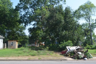 City workers clear vacant property  on 18th Street in Ensley.