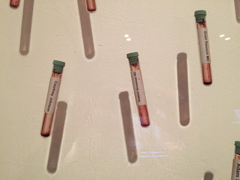 Real vials of blood suspended in art in "Community Pint" by Jordan Eagles, on display at the Abroms-Engel Institute for the Visual Arts at UAB.