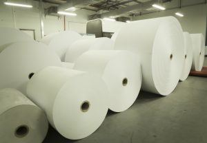 Large newsprint rolls storage at newspaper plant.