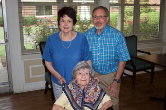 Dorothy Levy and her children, Janice and Robert, in the dining hall at Greenbrier Assisted Living Facility in Birmingham.